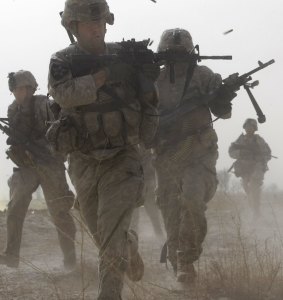 A U.S. soldier returns fire as others run for cover during a firefight with insurgents in the Badula Qulp area, West of Lashkar Gah  in Helmand province, southern Afghanistan,