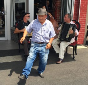 Local man Rocky Paoletti, 78, dances to a band outside Mr Piccolo cafe in Macaulay Road, Kensington.