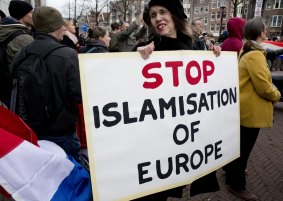 A woman holds a placard during a Pegida demonstration against immigration and Islamisation in Amsterdam, Netherlands. in February.