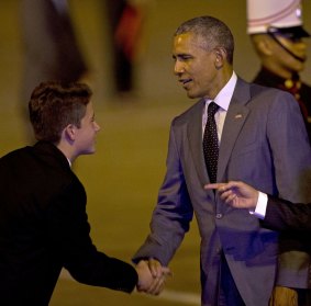 US President Barack Obama meets Stefan Varela, son of Panama's President Juan Carlos Varela, as he arrives for the VII Summit of the Americas in Panama City.
