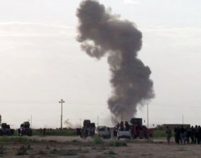 Smoke rises from an explosion as Iraqi forces, Shiite militiamen and Sunni tribal fighters battle Islamic State.