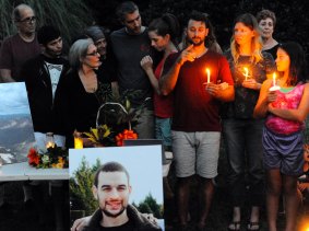 Sam Harris, centre, older brother of Daniel Harris signs to the crowd during a candlelight vigil to remember Daniel Harris, pictured. 