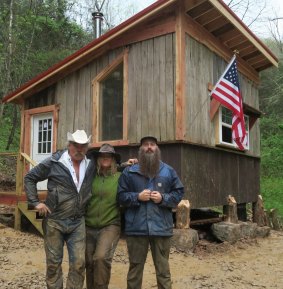 Homestead Rescue's Marty, Misty and Matt Raney with a newly built cabin.