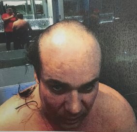 Jaron Chester is photographed by Michael Ibrahim with his head shaved as punishment for allegedly stealing laundered funds.