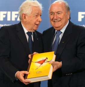 Frank Lowy submits Australia's official bid book for the  Soccer World Cup to Sepp Blatter in 2010.