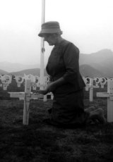 Bereaved Australian mother Thelma Healy kneeling at her son’s war grave in Pusan, Korea,  in 1961.