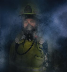 Senior Firefighter Brett Musial in the doorway of the hot/smoke house at the ACT Fire and Rescue training centre in Hume. 