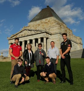 Footballers Ben Griffiths of Richmond and Chris Dawes of Melbourne with Michael Allen, Jenny Hughes-Allen, Norma Hughes, Luke Allen and Steven Allen, all descendants of Frank 'Checker' Hughes, at the Shrine of Remembrance.