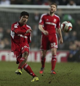 Club colours: Massimo Luongo puts boot to ball for Swindon Town.