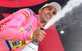 Spain's Aberto Contador celebrates on the podium of the 18th stage.