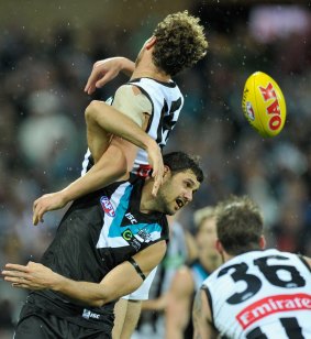 In a twist: Jarrod Witts of the Magpies and Patrick Ryder clash for the ball.