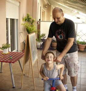 Minos Prinarakis plays with his son Sofoklis at home in Larissa, Greece, in 2015. 