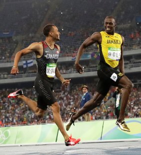 "Not needed": Bolt pulls ahead of De Grasse after his late charge.
