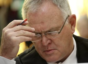 Pistorius' defence lawyer Barry Roux waits before the Supreme Court  hearing gets under way.