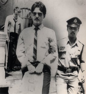 Brian Geoffrey Chambers, foreground, and Kevin Barlow are led away from a Malaysian court where they were facing the death penalty for drug trafficking in July 1986.