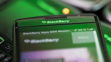 The BlackBerry logo is seen on the screen of a BlackBerry smartphone.
