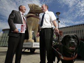 National Disability Services ACT manager Stephen Fox and guide dog handler John Barlow with Jazzy.