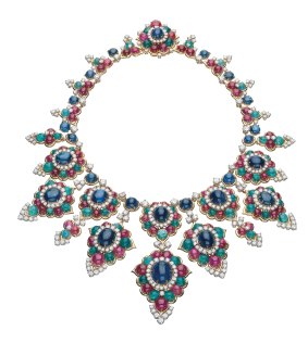 A gold Bulgari necklace decorated with 10 large floral clusters set with 25 cabochon sapphires, 71 cabochon emeralds, 88 cabochon rubies and 348 brilliant-cut diamonds. The back is formed of similarly set foliate motifs.