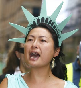 A woman dressed as the Statue of Liberty protests against US President Donald Trump's travel ban in Sydney.