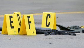A weapon lays on the ground next to evidence markers in Bristol, Tennessee.