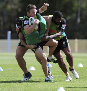 Raiders halfback Sam Williams gets tackled by two teammates at training this week.