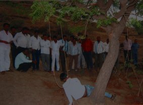 Lynching: Men surround Nitin Aage's body as it hangs from a tree near the central Indian village of Kharda, 330 kilometres east of Mumbai. He was killed on April 28, 2014.