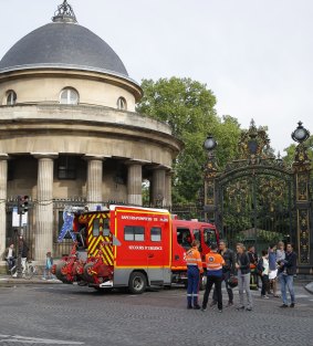A fire truck is parked at the entrance to Parc Monceau.  The lightining strike left an adult and three children fighting for their lives.