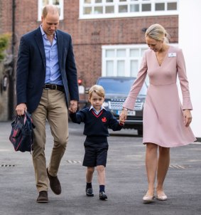 Britain's Prince William, left, accompanies Prince George and Helen Haslem - the head of the lower school on arrival for his first day of school at Thomas's school in Battersea.