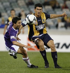 Nik Mrdja of the Mariners and Jacob Burns of the Glory challenge for the ball during the round five A-League match between the Central Coast Mariners ans the Perth Glory at Canberra Stadium on September 4, 2009.