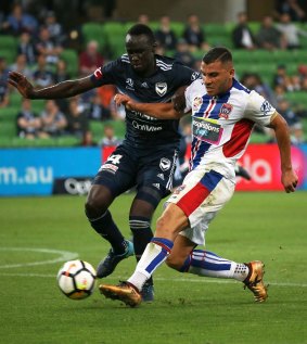 Victory's Thomas Deng puts pressure on the shot by Andrew Nabbout.
