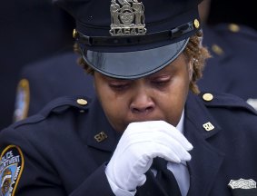 A police officer leaves the funeral for slain New York Police Department officer Wenjian Liu.