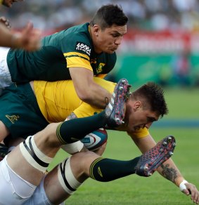 Australia's Sean McMahon, centre, feels the full force of the Springboks.