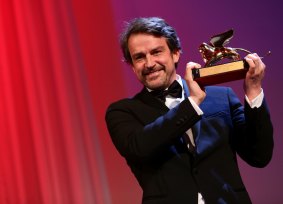 Director Lorenzo Vigas on stage with the Golden Lion Award for Best Film for <i>From Afar</i> at the closing ceremony during the 72nd Venice Film Festival on Sunday. 