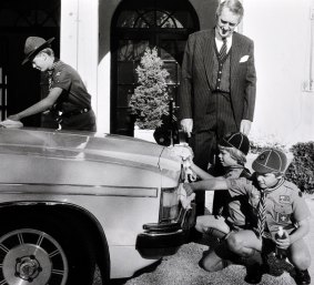 Malcolm Fraser looks on as David Mawson, 14, Hugh Withycombe, 10, and David Freney, 20, polish his car back in 1981. 
