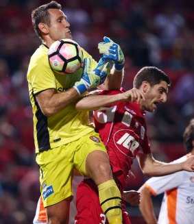 Brisbane's Michael Theo makes a save against Iacopo La Rocca of Adelaide United during their 1-1 draw.