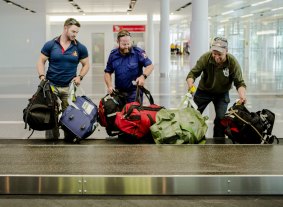 Returning ACT Remote Area Firefighters arrive at Canberra Airport. 
From left, Harley McDonnell, Matt White, and Terry Dwyer.