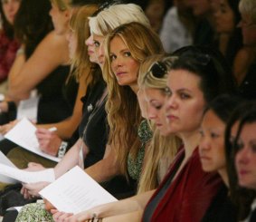 Supermodel Elle Macpherson (centre) writing for a fashion magazine at local designer Lisa Ho show in 2002.
