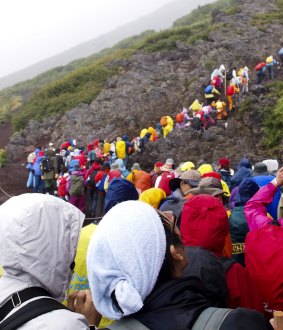 A steady stream of hikers head to the  summit of Mount Fuji.