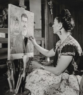 <i>Frida Painting the Portrait of Her Father</i>, by Gisele Freund, 1951 © Frida Kahlo Museum