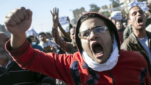 Divided land: A Muslim Brotherhood supporter demonstrates in Cairo after the bombings.