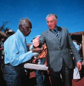 Then-Prime Minister Gough Whitlam pours sand into the hand of Vincent Lingiari in 1975.
