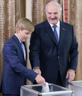 Lukashenko casts his ballot with Nikolai at a polling station during the presidential election in Minsk, Belarus, on Sunday, October. 11, 2015.
