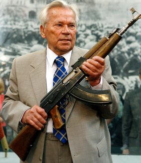 Mikhail Kalashnikov holds a prototype of his famous AK-47 assault rifle in 2007.