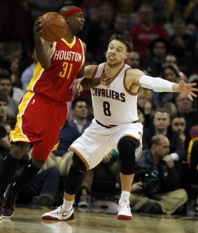 Gritty guard: Matthew Dellavedova, who has the misfortune of having his locker next to the world's best player LeBron James, tries to stop Houston's Jason Terry.