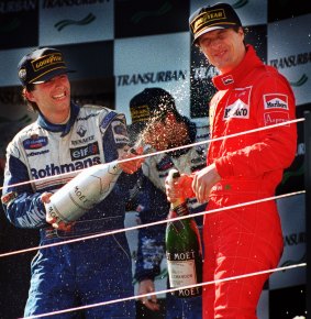 Winner of the 1996 Grand Prix, Damon Hill of Britain, sprays champagne on compatriot, and third place getter Eddie Irving.