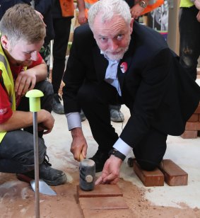 Britain's Labour Party leader Jeremy Corbyn lays bricks during his campaign visit to Derwentside College in Consett, on June 5.