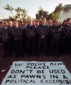A line of Victorian police officers stand in front of a sign made by picketers asking them not to become involved in the dispute. Swanson Dock, Melbourne. April 18, 1998. 