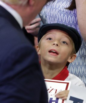 A young boy looks up at Donald Trump during a campaign stop Monday in Tennessee.