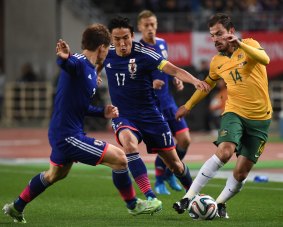 Defeated: James Troisi with the ball during the Socceroos loss in an international friendly match with Japan on Tuesday.  