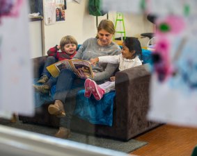 Felix and Riha, both 4, learn while they read with Gracie Pupillo at Flemington Street Children's Centre.